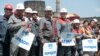 Workers of Illich Iron & Steel Works factory gather together holding posters "March. Discipline." during an anti-war rally in Mariupol, eastern Ukraine, May 20, 2014.