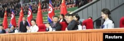 North Korean leader Kim Jong Un, his wife, Ri Sol Ju, China's President Xi Jinping and his wife, Peng Liyuan, attend a mass display during Xi's visit in Pyongyang, North Korea, in this undated photo released June 21, 2019 by North Korea's Korean Central News Agency.