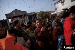 Believers enter the government-sanctioned Catholic church during a mass on Palm Sunday in Youtong village, Hebei province, China, March 25, 2018.