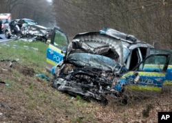 A damaged police car is seen next to a road in Langen near Frankfurt, Germany, Sunday, March 31, 2019.