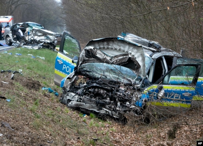 A damaged police car is seen next to a road in Langen near Frankfurt, Germany, Sunday, March 31, 2019.