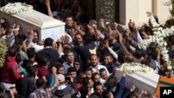 Relatives and friends carry the coffins of brothers Nadi Yousef Shehata, right, and Reda Yousef Shehata, two of the seven victims of an Islamic State ambush, in Minya, Egypt, Nov. 3, 2018.