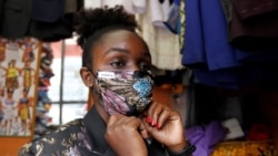Kenyan fashion designer Ruth Martin fits a protective face mask as part of her latest creation inside her studio, as a measure to stem the growing spread of the coronavirus disease (COVID-19) outbreak, in downtown Nairobi, Kenya April 9, 2020. REUTERS/Nje
