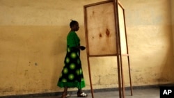 FILE - A voter walks toward a voting booth in Bujumbura, Burundi, as people prepared to vote in a presidential election.