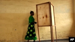 FILE - A woman walking towards a voting booth in Bujumbura, Burundi, as people prepared to vote in a presidential election, June 28, 2010.