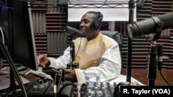 Boubacar Ba records a weekly call-to-listen politics show for the Malian diaspora in New York's Zeno Media studios.