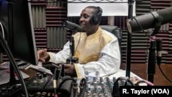 Boubacar Ba records a weekly call-to-listen politics show for the Malian diaspora in New York's Zeno Media studios.