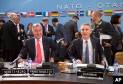 FILE - NATO Secretary-General Jens Stoltenberg, right, and Montenegro's Prime Minister Milo Dukanovic, left, take their seats during a meeting of the North Atlantic Council and Montenegro at NATO headquarters in Brussels, May 19, 2016.