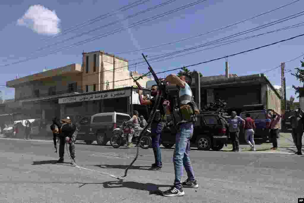 Hezbollah supporters fire in the air to celebrate the arrival of Iranian fuel tankers to Lebanon, in the eastern town of Baalbek. The delivery violates U.S. sanctions imposed on Tehran after former President Donald Trump pulled America out of a nuclear deal between Iran and world powers three years ago. 