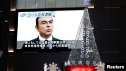 A street monitor showing a news report about arrest of Nissan Chairman Carlos Ghosn is seen in Tokyo, Japan, Nov. 21, 2018.