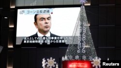 A street monitor showing a news report about arrest of Nissan Chairman Carlos Ghosn is seen in Tokyo, Japan, Nov. 21, 2018.