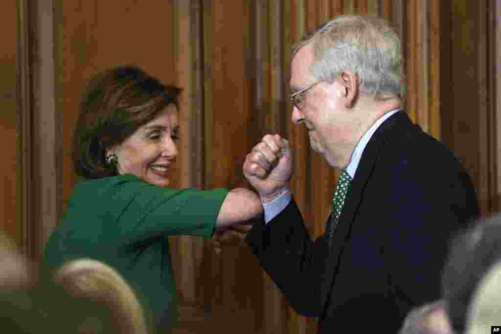 House Speaker Nancy Pelosi, left, and Senate Majority Leader Mitch McConnell, right, bump elbows as they attend a lunch with Irish Prime Minister Leo Varadkar on Capitol Hill in Washington, D.C.