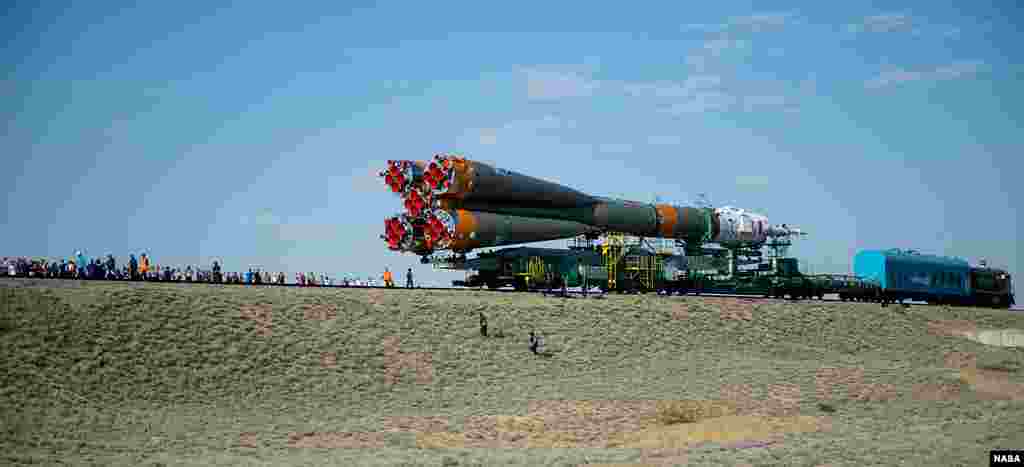 Guests and members of the media watch as the Soyuz TMA-13M spacecraft is rolled out to the launch pad by train at the Baikonur Cosmodrome in Kazakhstan. Launch of the Soyuz rocket is scheduled for May 29 and will send Expedition 40 Soyuz Commander Maxim Suraev of the Russian Federal Space Agency, Roscosmos, Flight Engineer Alexander Gerst of the European Space Agency, ESA, and Flight Engineer Reid Wiseman of NASA on a five and a half month mission aboard the International Space Station.