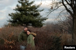 Jenny Ostrom, 37, a director of photography and her husband Chad Ostrom, 37, a director, stand in McCarren Park, near their home in the Brooklyn borough of New York, Feb. 8, 2018.