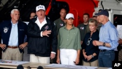 President Donald Trump, first lady Melania Trump and Vice President Mike Pence, left, participate in a briefing on the Hurricane Irma relief efforts, Sept. 14, 2017, in Ft. Myers, Fla., after arriving at Southwest Florida International airport. 