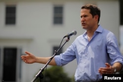 FILE - Congressman Seth Moulton (D-MA) speaks at a Merrimack County Democrats Summer Social at the Swett home in Bow, New Hampshire, July 28, 2018.