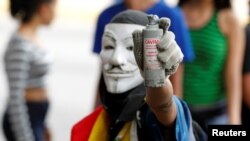 An opposition demonstrator shows a tear gas grenade while clashing with riot police during the so called "mother of all marches" against Venezuela's President Nicolas Maduro in Caracas, Venezuela, April 19, 2017.