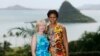 FILE - U.S. first lady Michelle Obama poses with Laureen Harper, spouse of then-Canadian Prime Minister Stephen Harper, at Kualoa Ranch on the east side of Oahu in Kaaawa, Hawaii, Nov. 13, 2011. The island of Mokolii, also know as the Chinaman's Hat island, in the background.