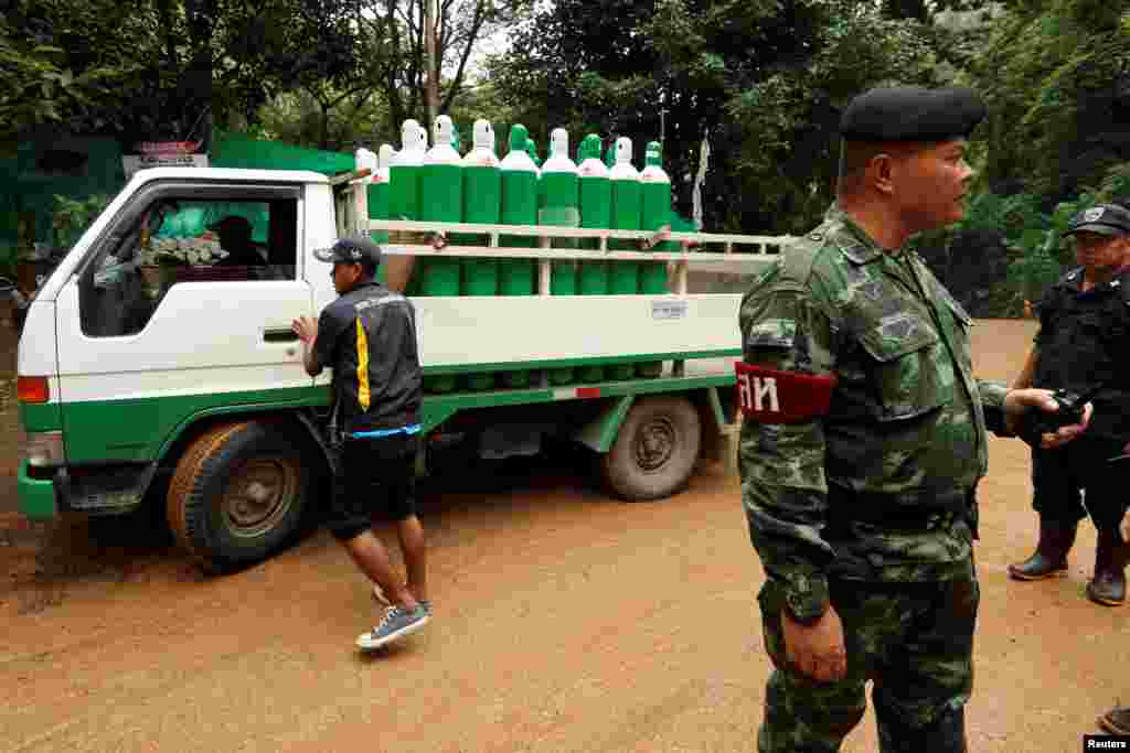 A truck carrying oxygen tanks arrives outside the Tham Luang cave complex, July 8, 2018.