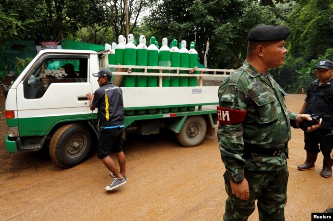 A truck carrying oxygen tanks arrives outside the Tham Luang cave complex, July 8, 2018.