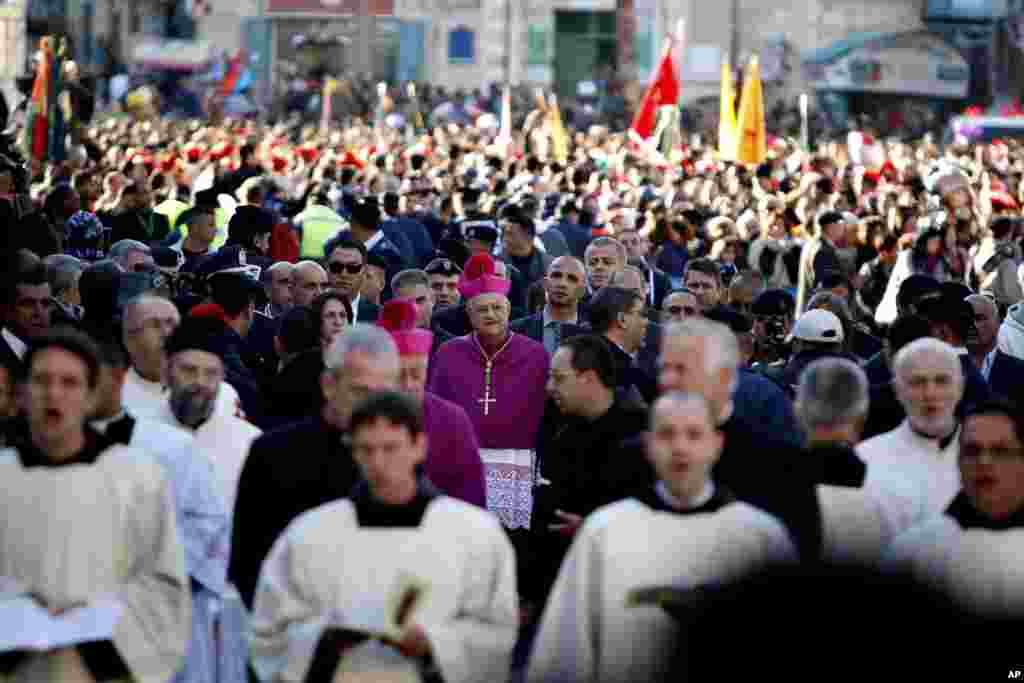 Latin Patriarch of Jerusalem Fouad Twal arrives at the Church of the Nativity in the West Bank town of Bethlehem, Dec. 24, 2013.