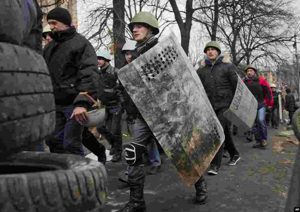 Protesters march towards government buildings in central Kyiv.