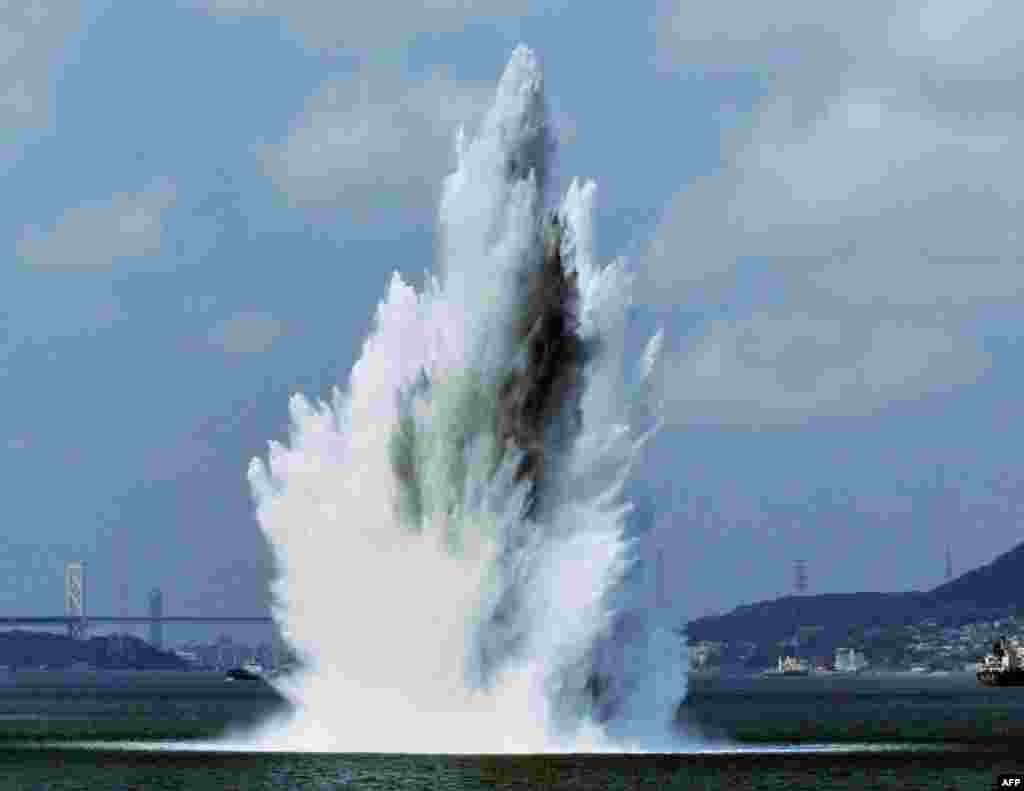 A nearly 100-meter-tall and 60-meter-wide column of water rises up as a World War II mine explodes during a mine sweeping operation in the Kanmon Strait off Shimonoseki, Yamaguchi prefecture, Japan.