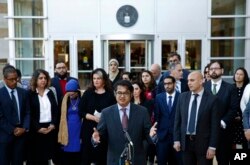 Omar Jadwat, center, director of the ACLU's Immigrants' Rights Project, speaks at a news conference outside a federal courthouse in Greenbelt, Maryland, Oct. 16, 2017, following a hearing regarding three lawsuits over the Trump administration's restrictions on travelers from certain countries.