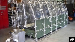 In this undated photo released by the Center for Disease Control, a Aeromedical Biological Containment System which looks like a sealed isolation tent for Ebola air transportation is shown.