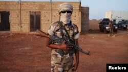 An ethnic Tuareg Malian soldier under the command of Col. El Hadj Ag Gamou stands guard at a checkpoint in Gao, Mali, March 3, 2013.