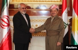 FILE - Iraqi Kurdish regional President Masoud Barzani, right, shakes hands with Iranian Foreign Minister Mohammad Javad Zarif in Irbil, Aug. 26, 2014.