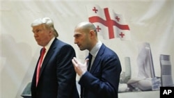 Real estate developer Donald Trump, left, and George Ramishvili, Chairman of Silk Road Group, talk following a news conference in New York, March 10, 2011
