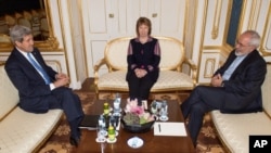 FILE - US Secretary of State John Kerry, former EU Foreign Policy Chief Catherine Ashton and Iranian Foreign Minister Mohammad Javad Zarif meet for talks on the sidelines of nuclear talks with Iran aimed at settling a dispute over Iran's nuclear program at the Palais Coburg in Vienna on Saturday Nov. 22, , 2014. 
