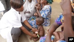 A doctor attends to a Malnourished child as women and children rescued by Nigerian soldiers wait to receive treatment at a refugee camp in Yola, Nigeria, after being rescued from captivity by Boko Haram fighters, May 3, 2015. 