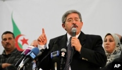 FILE - Algerian Prime Minister Ahmed Ouyahia speaks during a meeting of the National Rally for Democracy in Algiers.