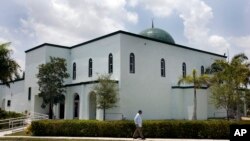 FILE - A man is seen walking past a mosque in Margate, Florida, in a May 14, 2011, photo.