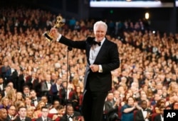 John Lithgow accepts the award for outstanding supporting actor in a drama series "The Crown" on the red carpet stage at the 69th Primetime Emmy Awards, Sept. 17, 2017, at the Microsoft Theater in Los Angeles.
