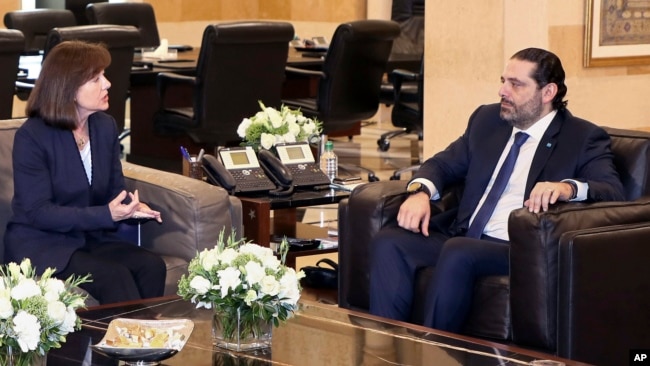 FILE - United States Ambassador to Lebanon Elizabeth Richard, left, speaks with Lebanese Prime Minister Saad Hariri, at the government House, in Beirut, Feb 19, 2019. Richard has expressed her country's concerns over the growing role of the militant Hezbollah.