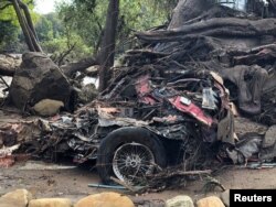 Parts of a damaged car are entangled in debris after mudslides in Montecito, California, U.S. in this photo provided by the Santa Barbara County Fire Department, Jan. 9, 2018.