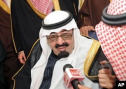 Saudi Arabia's King Abdullah speaks to Saudi media upon his arrival at Riyadh airport, February 23, 2011