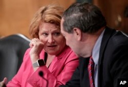Sen. Heidi Heitkamp, D-N.D., (L) and Sen. Joe Donnelly, D-Ind., listen as the Senate Banking Committee holds a hearing on U.S. economic sanctions against Russia and whether the actions are effective, on Capitol Hill in Washington, Aug. 21, 2018.