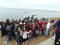 The group prepares to end the cleanup with a Hindu prayer.