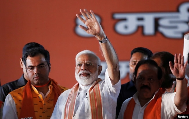India's Prime Minister Narendra Modi waves toward his supporters during an election campaign rally in New Delhi, May 8, 2019.
