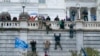 Supporters of President Donald Trump climb the west wall of the the U.S. Capitol on Wednesday, Jan. 6, 2021, in Washington.