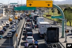 Cars and trucks line up to enter Mexico from the U.S. at a border crossing in El Paso, Texas, March 29, 2019.