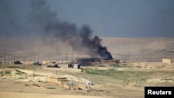Smoke rises from clashes as Iraqi security forces engage in a battle with Islamic State militants in south of Mosul, Iraq, Feb. 19, 2017.