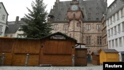 A view of closed booths of a Christmas market that will open its doors in the upcoming days, in front of the townhall in Marburg, Germany, Nov. 17, 2021.