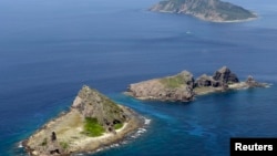 FILE - A group of disputed islands, Uotsuri island (top), Minamikojima (bottom) and Kitakojima, known as Senkaku in Japan and Diaoyu in China is seen in the East China Sea, in this photo taken by Kyodo, September 2012. 