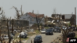 A motorcade carrying President Obama passes through a devastated Joplin, Mo., neighborhood Sunday, May 29, 2011.