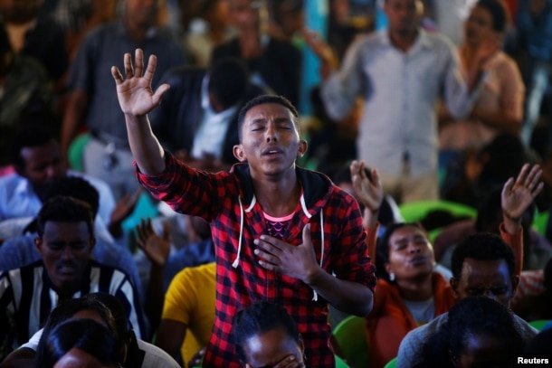 A man attends a prayer session at Biftu Bole Lutheran Church during a prayer and candle ceremony for protesters who died in the town of Bishoftu, in Addis Ababa, Ethiopia, Oct. 16, 2016.